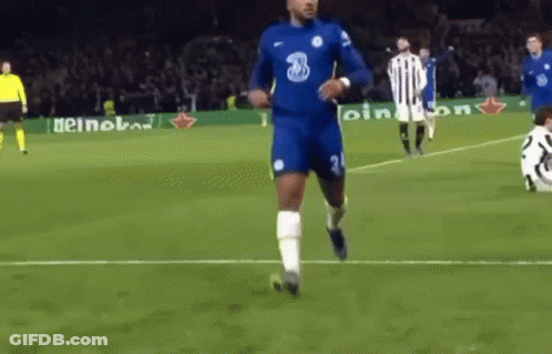 A Soccer Player Is Running On A Soccer Field With A Ball In His Hand . GIF