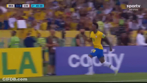 A Soccer Player Is Running On The Field In Front Of A Banner That Says Ola GIF
