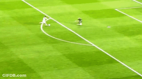 A Soccer Player Is Running Towards A Goal While Another Player Lays On The Ground . GIF