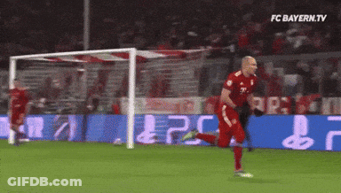 A Soccer Player Is Running Towards A Goal With Fc Bayern.tv In The Corner GIF