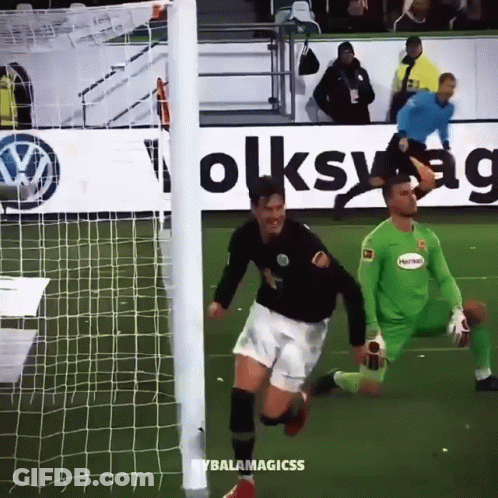 A Soccer Player Is Running Towards The Goal While Another Player Watches GIF