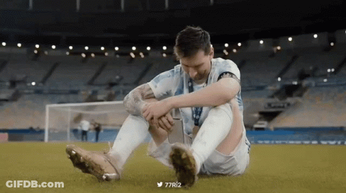 A Soccer Player Is Sitting On The Field With His Knee In Pain GIF