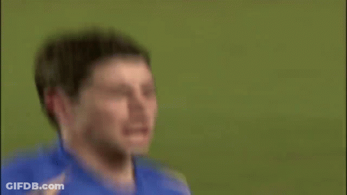 A Soccer Player Is Sitting On The Ground With A Playstation Sign In The Background GIF