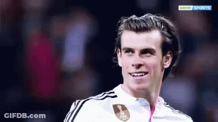 A Soccer Player Is Smiling In Front Of A Hopper Sports Logo GIF