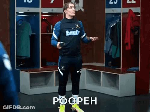 A Soccer Player Is Standing In A Locker Room With The Words Poopeh Written On The Floor . GIF