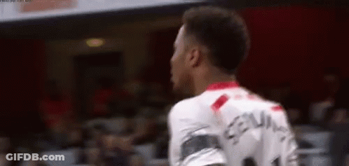 A Soccer Player Is Standing In Front Of A Crowd While Wearing A White Jersey With The Number 11 On It . GIF