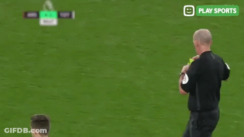 A Soccer Player Is Standing Next To A Referee On A Field . GIF