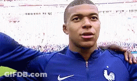 A Soccer Player Is Standing On A Field With His Arm Around Another Player . GIF