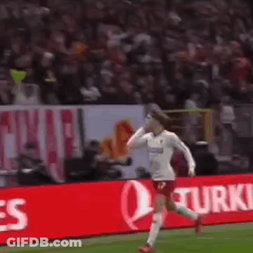 A Soccer Player Is Standing On The Field In Front Of A Large Crowd . GIF