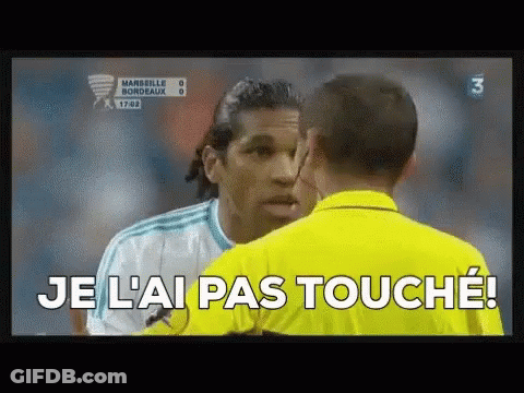A Soccer Player Is Talking To A Referee Who Is Wearing A Yellow Shirt That Says Je L' Ai Pas Touche ! GIF