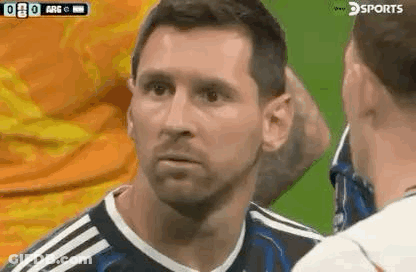 A Soccer Player Is Talking To Another Soccer Player On The Field . GIF