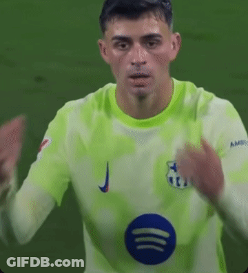 A Soccer Player Is Wearing A Green Jersey With A Blue Circle On The Front . GIF