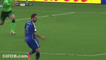 A Soccer Player Jumps To Catch A Ball In Front Of An Advertisement For Lib GIF