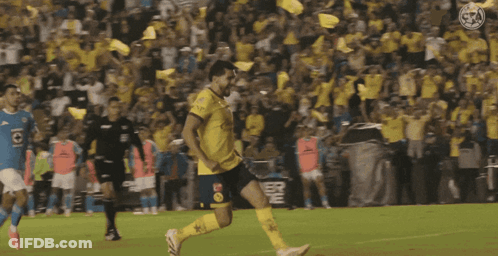 A Soccer Player Kicking A Ball In Front Of A Crowd With A Powerade Sign In The Background GIF