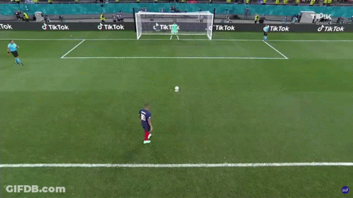 A Soccer Player Kicking A Ball In Front Of A Goal With Tik Tok Advertisements GIF