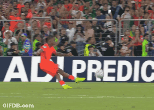 A Soccer Player Kicking A Ball In Front Of An Ad For Ad Predic GIF