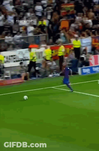A Soccer Player Kicking A Ball On A Field With A Sign That Says Footmood In The Background GIF
