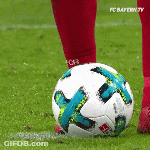 A Soccer Player Kicking A Soccer Ball On A Field . GIF