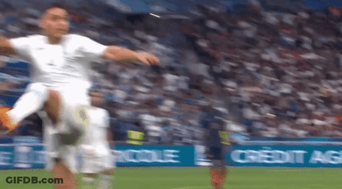 A Soccer Player Kicking A Soccer Ball On A Field With A Credit Agricole Banner In The Background GIF