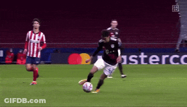 A Soccer Player Kicking A Soccer Ball On A Field With A Mastercard Sign In The Background GIF