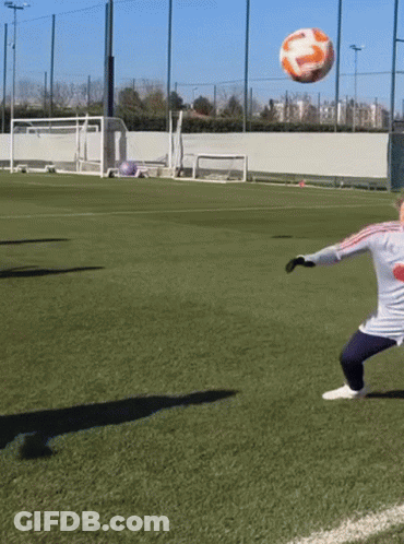 A Soccer Player Kicks A Ball On A Field That Has A Coca Cola Logo On His Shirt GIF
