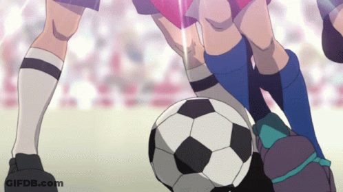 A Soccer Player Kicks A Ball While Another Player Tries To Stop Him GIF