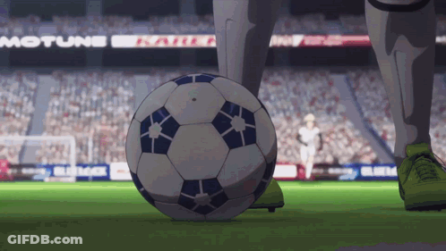 A Soccer Player Kicks A Soccer Ball On A Field With A Motune Sign In The Background GIF