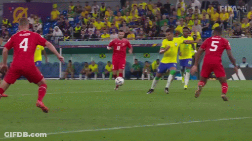 A Soccer Player Kicks The Ball In Front Of A Qatar Airways Banner GIF