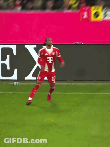A Soccer Player Kicks The Ball In Front Of A T-Mobile Banner GIF