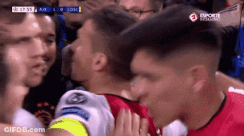 A Soccer Player Kisses Another Player On The Cheek During A Game Sponsored By Esporte Inferno GIF
