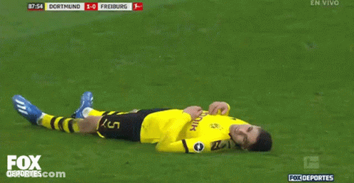 A Soccer Player Laying On The Field With The Fox Deportes Logo GIF