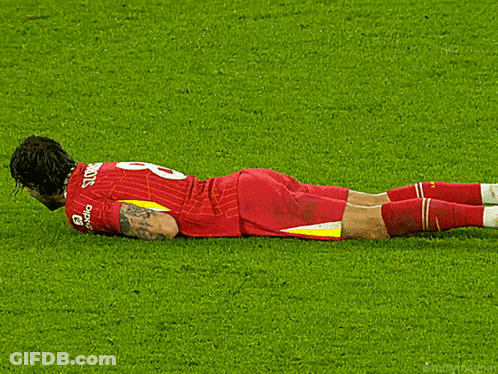 A Soccer Player Laying On The Field With The Number 8 On His Jersey GIF