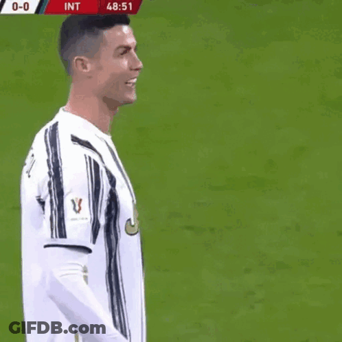 A Soccer Player Named Cristiano Ronaldo Is Laughing On The Field GIF