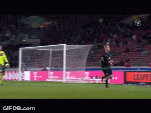A Soccer Player Runs Towards A Goal With A T-Mobile Ad In The Background GIF