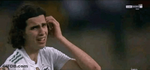 A Soccer Player Scratches His Head While Wearing A White Shirt GIF