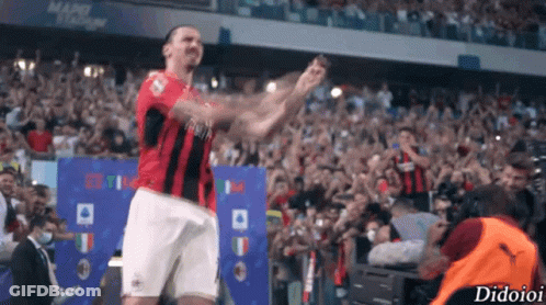 A Soccer Player Stands In Front Of A Crowd With The Word Didioi On The Bottom Right Corner GIF