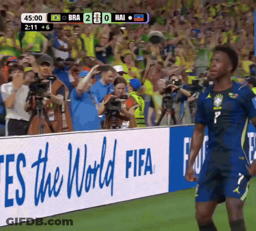 A Soccer Player Stands In Front Of A Fifa Sign GIF