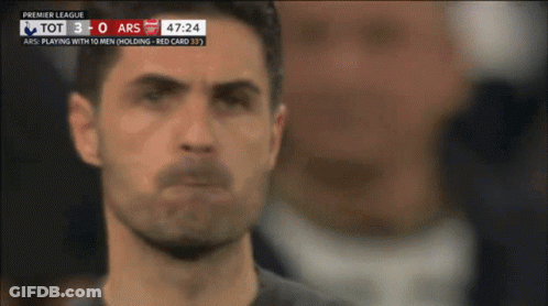A Soccer Player Stands In Front Of A Scoreboard That Says Premier League On It GIF