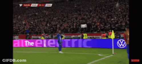 A Soccer Player Stands In Front Of A Sign That Says " All The Electric " GIF
