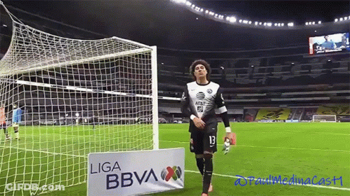 A Soccer Player Stands In Front Of A Sign That Says Liga Bbva GIF