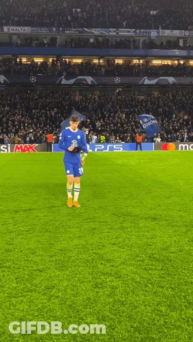 A Soccer Player Stands On A Field With A Ps5 Logo In The Background GIF