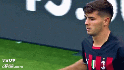 A Soccer Player Stands On A Field With The Words Futball Karim On The Bottom Right GIF