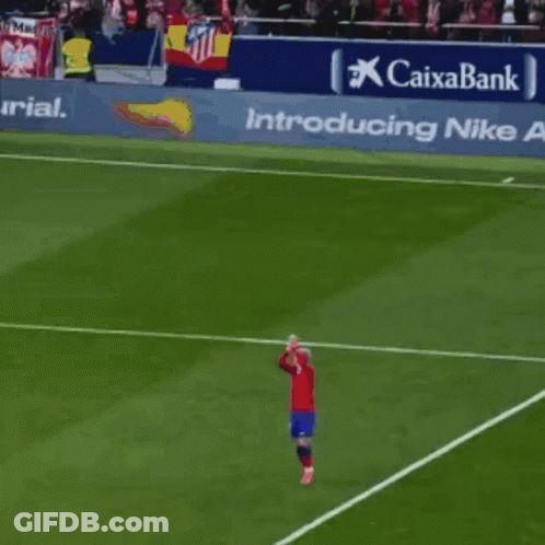 A Soccer Player Stands On The Field In Front Of A Banner That Says Caixabank GIF