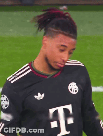 A Soccer Player Wearing A Black Adidas Jersey With A White T On It GIF