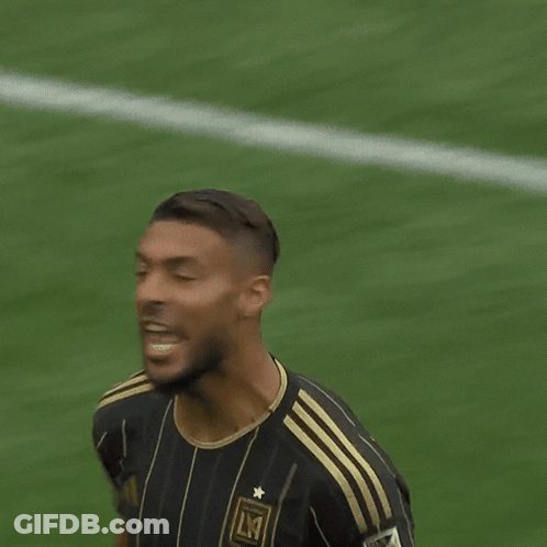 A Soccer Player Wearing A Black And Gold Jersey That Says Lmt On It GIF