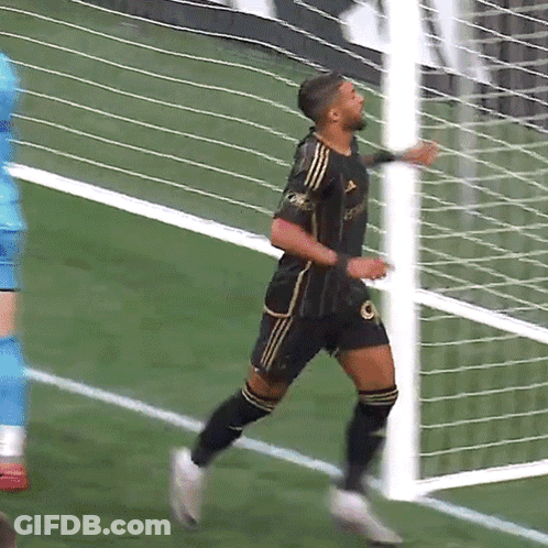 A Soccer Player Wearing A Black And Gold Jersey With The Word Adidas On It GIF