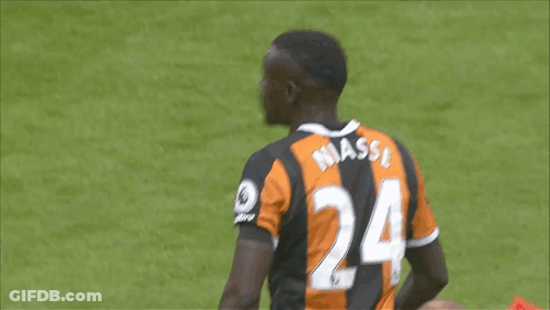 A Soccer Player Wearing A Black And Orange Jersey With The Number 24 On The Back GIF