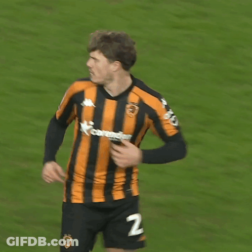 A Soccer Player Wearing A Black And Orange Striped Jersey With The Number 27 On The Back GIF