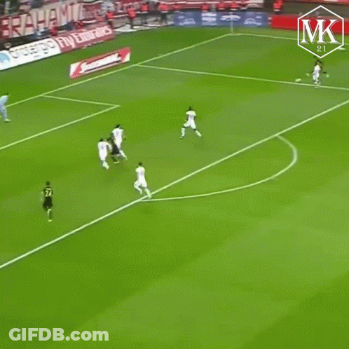 A Soccer Player Wearing A Black And Yellow Jersey Is Running On The Field GIF