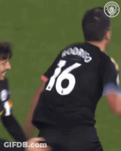 A Soccer Player Wearing A Black And Yellow Shirt With The Word Etihad On The Front GIF